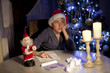 © Denizo - little boy writing wish list at home in the living room
