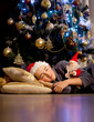 © Denizo - A boy sleeps under the Christmas tree