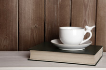 Old Books And Cup Of Coffee On Table