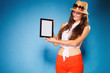 © Voyagerix - Girl showing blank copy space screen of tablet touchpad