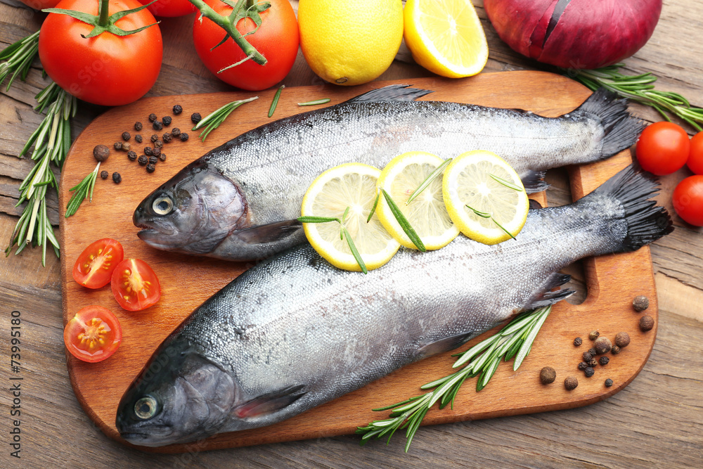 Fresh raw fish and food ingredients on table