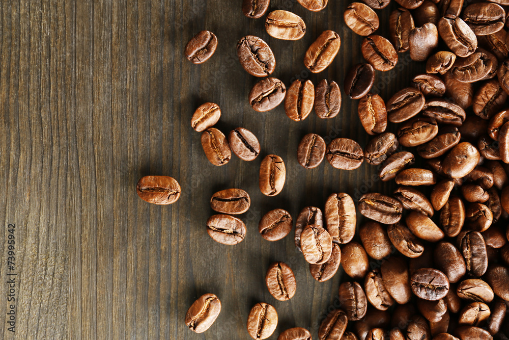 Coffee beans on wooden background, close-up