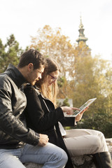 Wall Mural - Happy Couple Using Tablet Computer Outdoor