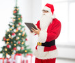 © Syda Productions - man in costume of santa claus with tablet pc
