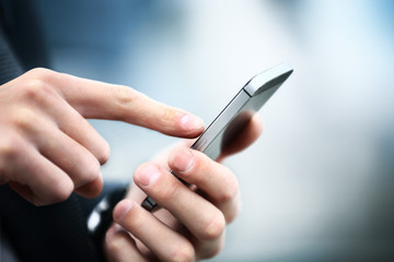 close up of a man using mobile smart phone