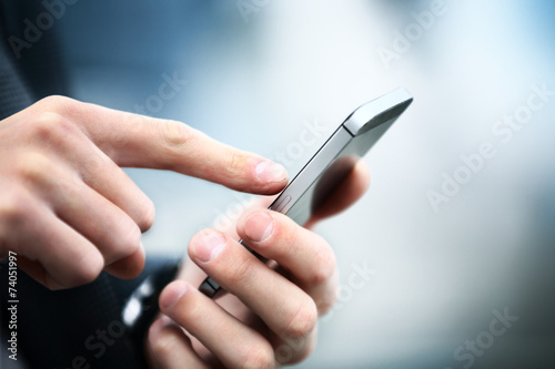 Fotografie, Obraz Close up of a man using mobile smart phone