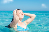 Fototapeta Abstrakcje - Young woman relaxing in a heavenly sea, Saleccia beach Corsica