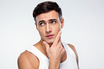 Poster - Portrait of a handsome man looking away over gray background