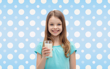 Canvas Print - smiling girl with glass of milk over polka dots