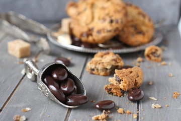 Wall Mural - Chocolate candy with chocolate chip cookies on wooden background