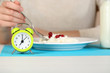 © Africa Studio - Alarm clock and dietary food on table close-up
