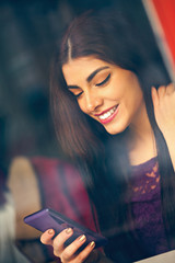 Wall Mural - Young Woman In Cafe Using Technology