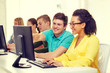 © Syda Productions - smiling students in computer class at school