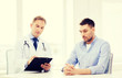 © Syda Productions - doctor with clipboard and patient in hospital
