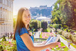 © golovianko - Smiling girl with city map in Mirabell Garden in Salzburg