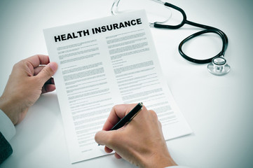 Wall Mural - young man signing a health insurance policy