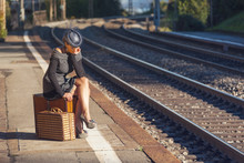 Woman Waiting At The Railway Station With A Suitecase
