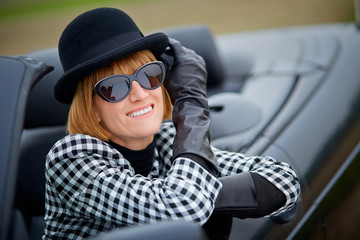 Stylish 40s woman happy with new Convertible