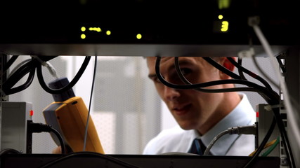 Poster - Technician using digital cable analyzer on server