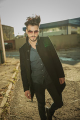 Canvas Print - Handsome fashion man posing near factories.