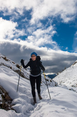 beautiful girl trekking on the mountain