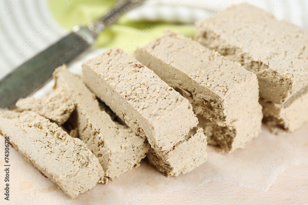 Sunflower halva on cutting board, on wooden background