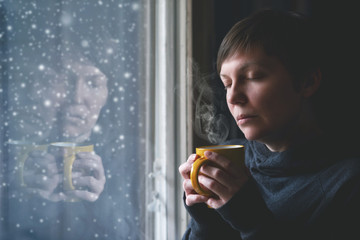 Lonesome Woman Drinking Coffee in Dark Room