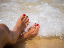 Closeup Of Woman Feet On The Beach