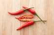 Red chilli peppers on wooden surface