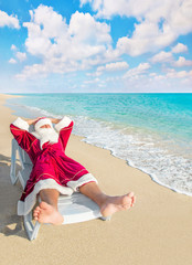 Poster - Santa Claus have a rest in chaise longue on sea beach