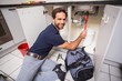 © WavebreakMediaMicro - Plumber fixing under the sink