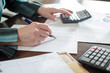 © thodonal - Female accountant checking financial documents