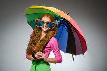 Woman Holding Colourful Umbrella In Studio