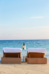 Loungers At Edge Of Tropical Sea With Champagne Bucket