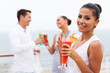 © michaeljung - girl holding a tropical cocktail on cruise