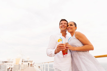 Wall Mural - low angle view of young couple with cocktail on cruise ship