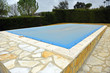 Swimming pool protected with a blue tarp, winter