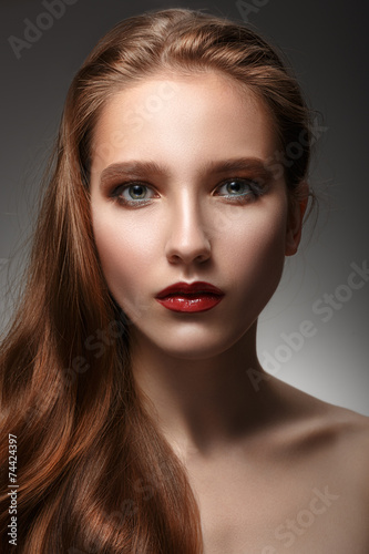 Fotografie, Obraz beautiful woman with perfect skin and long hair on a grey backgr