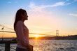 © olesyaturchuk - Young girl on background of Bosphorus bridge and sunset