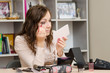 © madhourse - young girl wears a brush lashes at desk in office