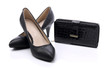 Women's shoes and a black wallet on a white background