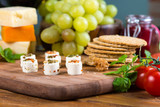 Fototapeta Miasto - small cheese snacks with cakes and grapes