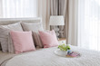 © 290712 - pink pillows on bed with tray of flower