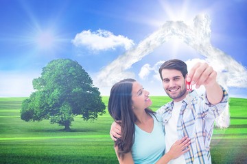Poster - Composite image of happy young couple showing new house key