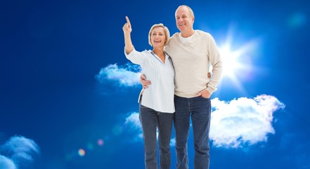 Poster - Composite image of happy mature couple walking together
