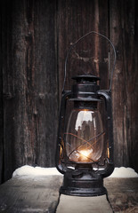 Sticker - Old oil lamp on vintage wooden table at night