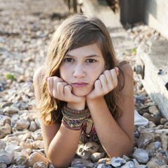 pensive girl lying on the beach