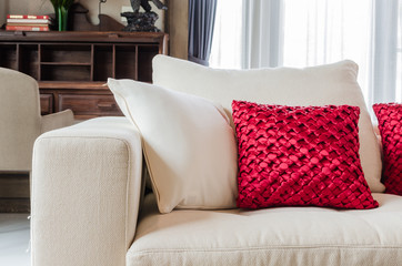 red and white pillow on white sofa at home