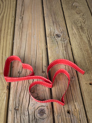 ribbon hearts against grungy wooden background