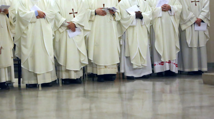 priest with the white cassock during the religious celebration